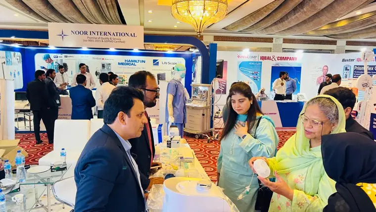 Clinicians at the product counter at a healthcare exhibition