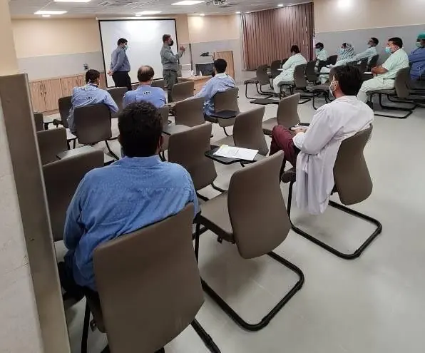 Doctors seated in a hospital auditorium during a product presentation