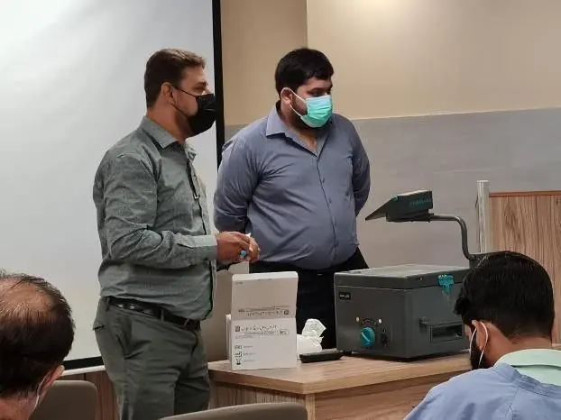 LabLink team members discussing a laboratory device with a clinician