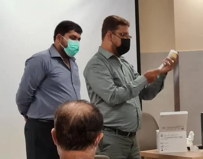 LabLink team members demonstrating a laboratory device to a clinician
