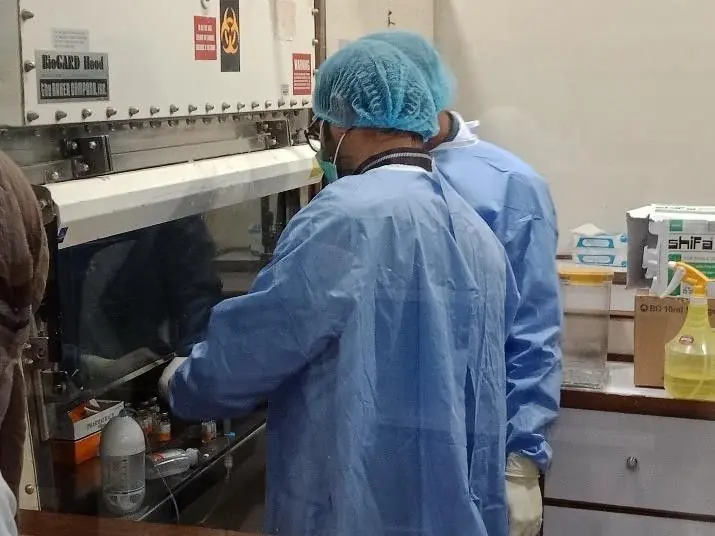 Laboratory staff in protective gowns during an on-site product session