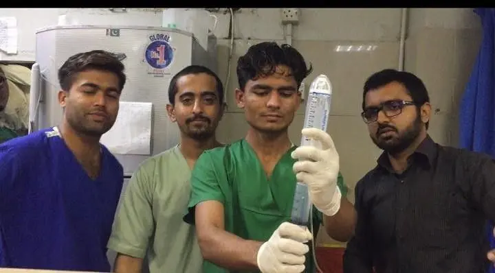 Young clinicians holding a medical device during training