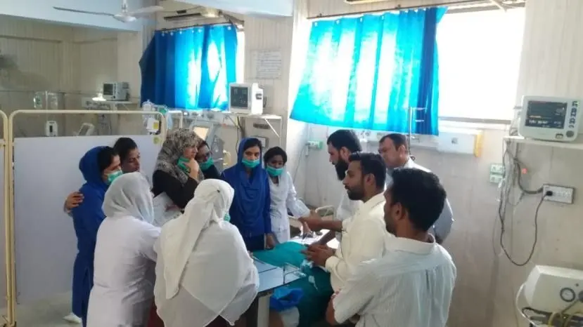 A LabLink specialist demonstrating a product to nursing staff at a hospital bedside